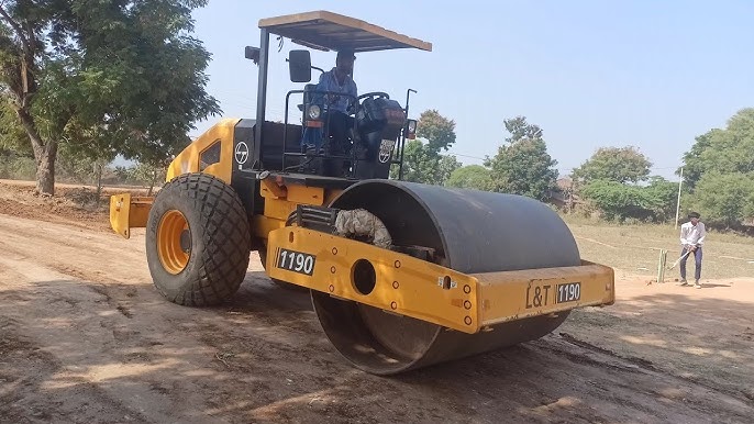 Vibratory roller compacting fresh asphalt