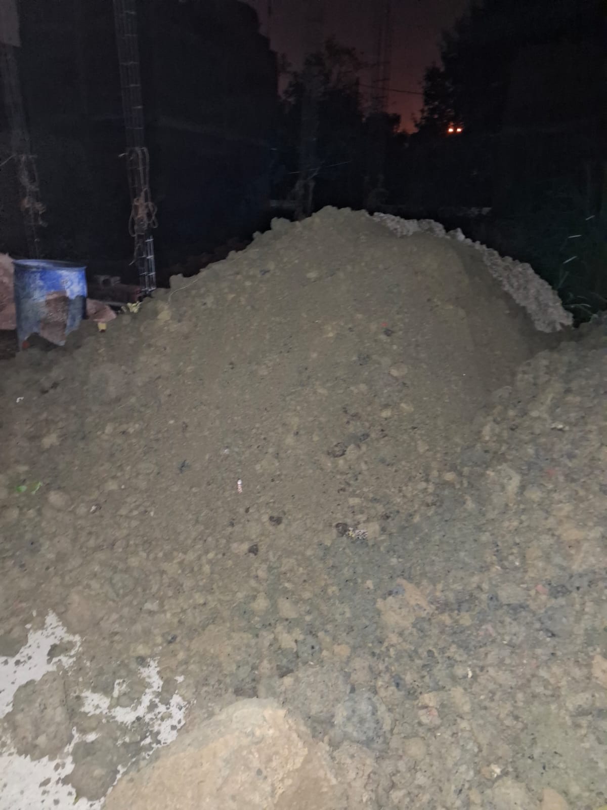 Stacked cement bags and sand stockpile ready for dispatch